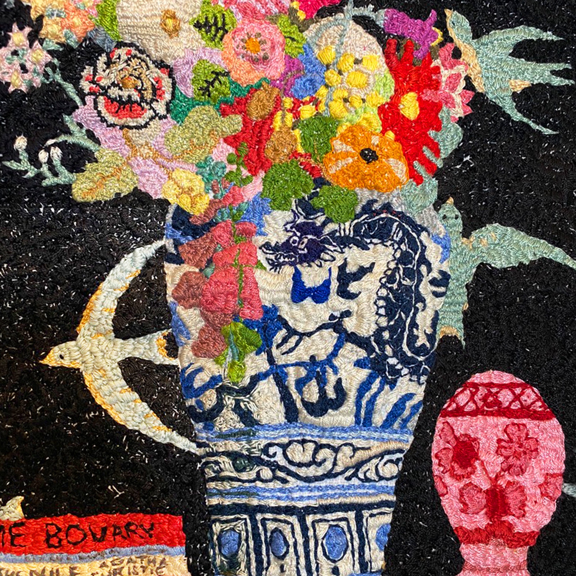 Hand embroidered textile artwork of a colourful flower arrangement in a blue and white vase