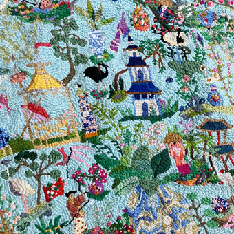 Blue embroidered textile with layered floral forms